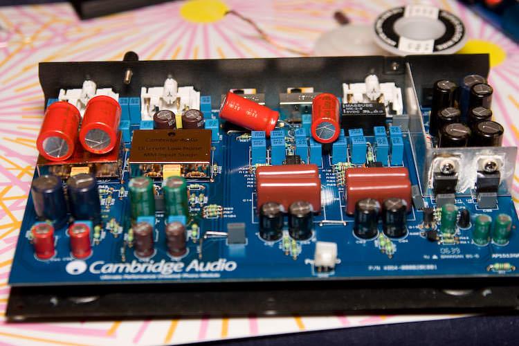 The finished board after the update, with red replacement electrolytics fitted across the input and supply sections
