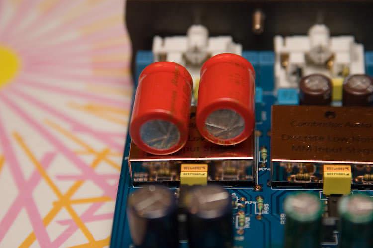 Two tall red capacitors standing over the copper-shielded MM input stage