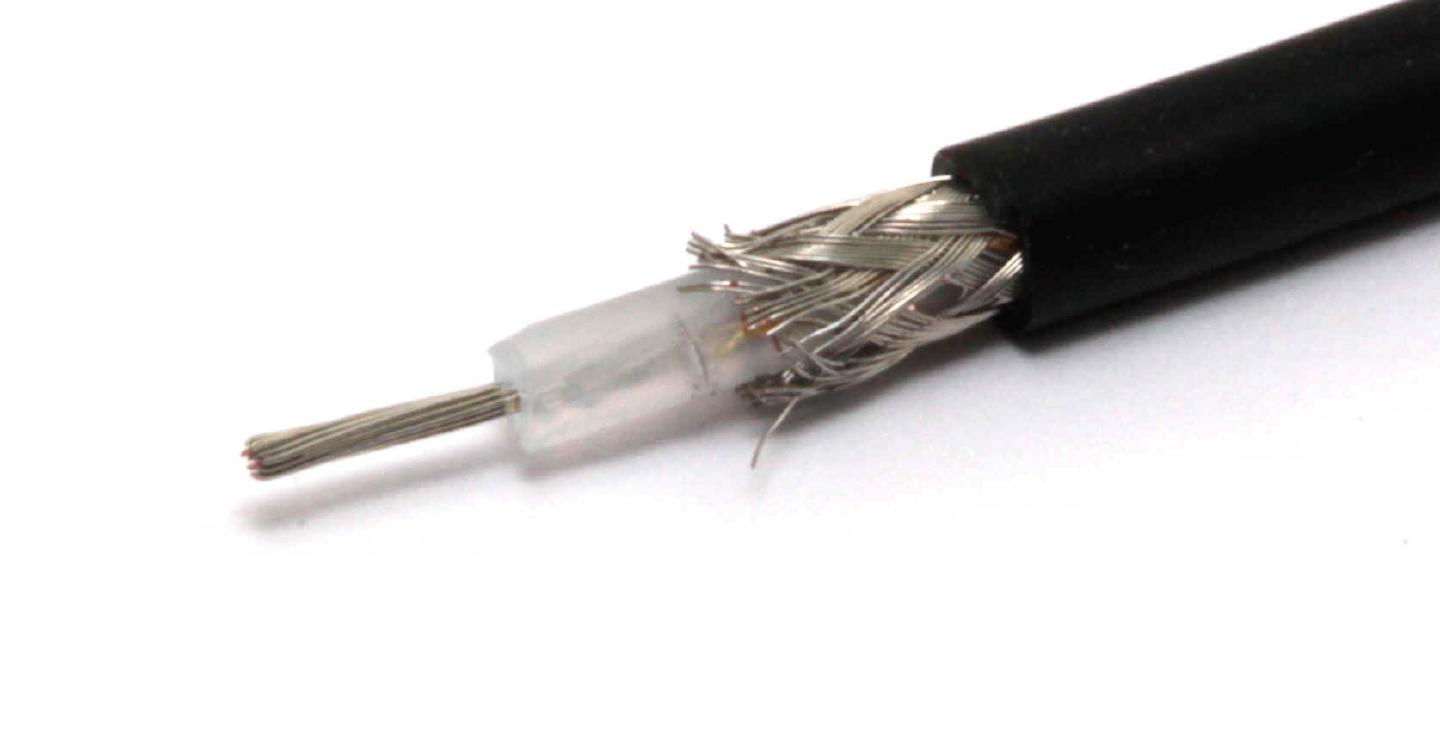 A length of coax stripped back in stages, showing the stranded centre conductor, the white dielectric and the braided shield