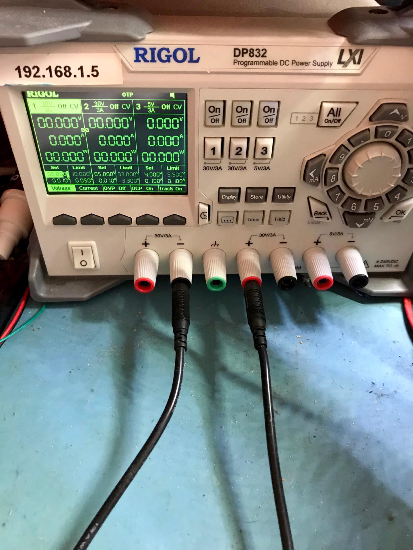 The Rigol DP832 bench supply with channel 1 set to 5.000 V and a 0.010 A limit, leads plugged into the 30V/3A outputs
