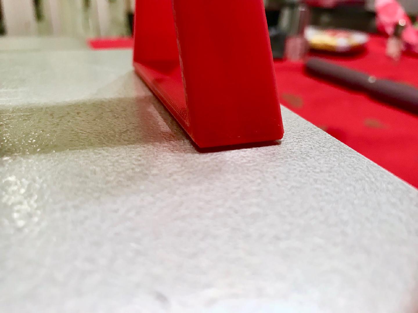 Close-up of the right-hand stand lifted clear of the bed, the visible gap being the 2 mm the axis was out