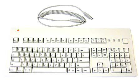 The beige Apple Extended Keyboard with its coiled ADB cable, full function row and numeric keypad