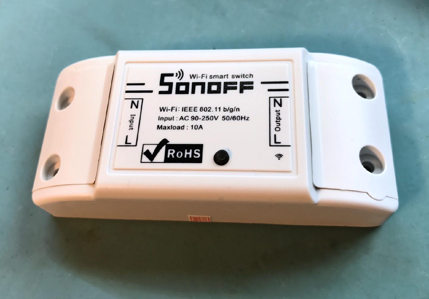 An unmodified Sonoff Wi-Fi smart switch, rated AC 90-250 V and 10 A max load